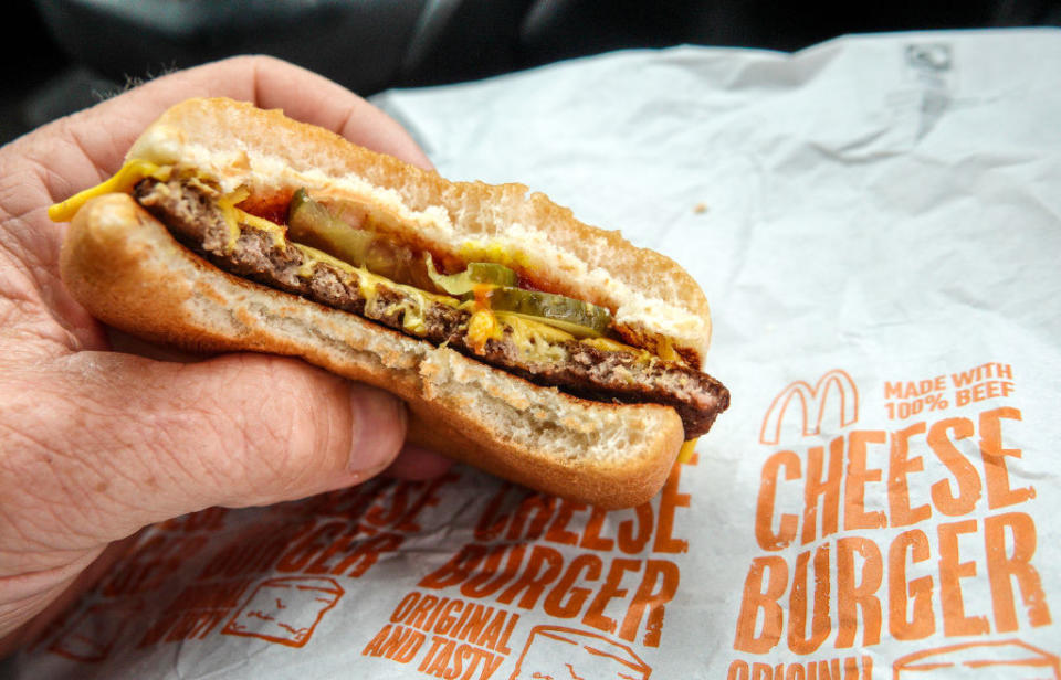 A man holding a McDonald's burger