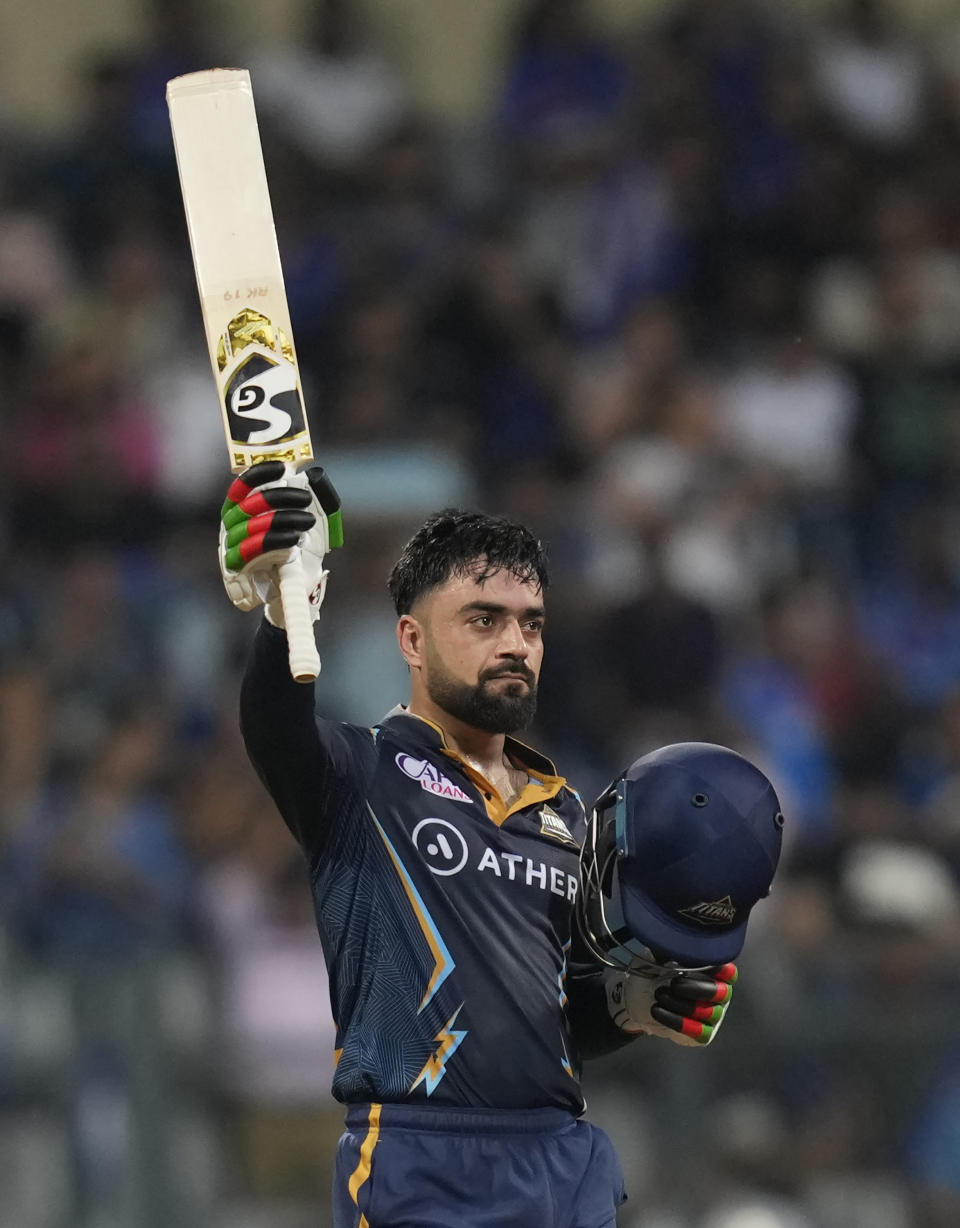 Gujrat Titans' Rashid Khan celebrates his fifty runs during the Indian Premier League cricket match between Mumbai Indians and Gujrat Titans in Mumbai, India, Friday, May 12, 2023. (AP Photo /Rajanish Kakade)