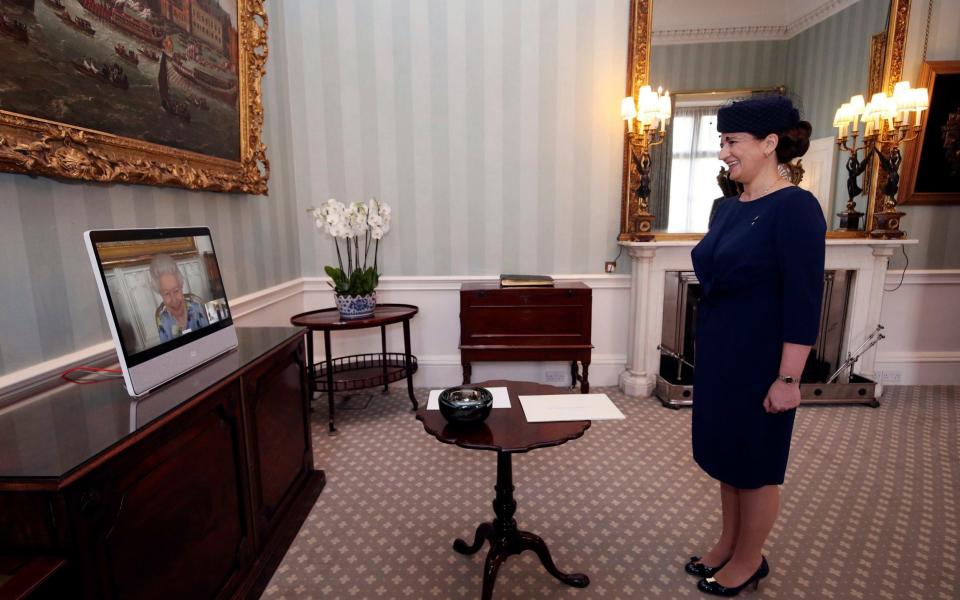 The Queen appears on a screen by videolink from Windsor Castle during a virtual audience to receive Ivita Burmistre, the Ambassador of Latvia - PA