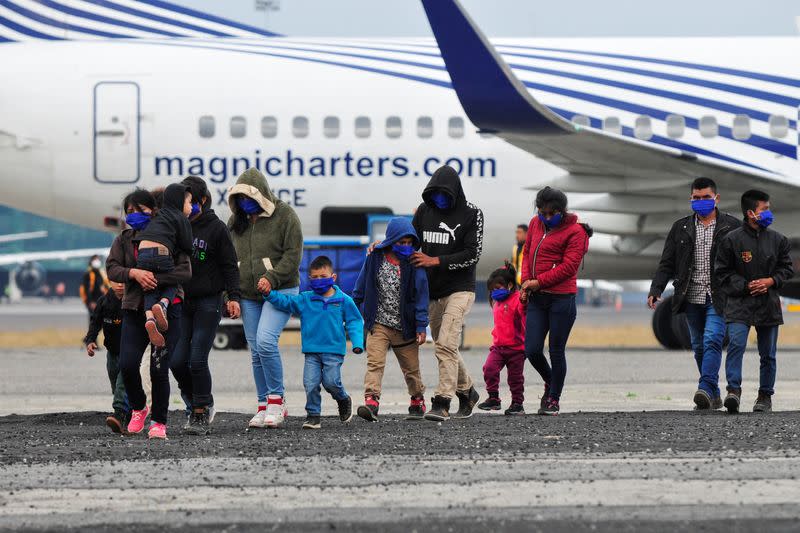 Guatemalan unaccompanied minors walk on the tarmac after arriving on a deportation flight from Mexico, at the Guatemalan Air Force (FAG) headquarters in La Aurora International Airport, in Guatemala City