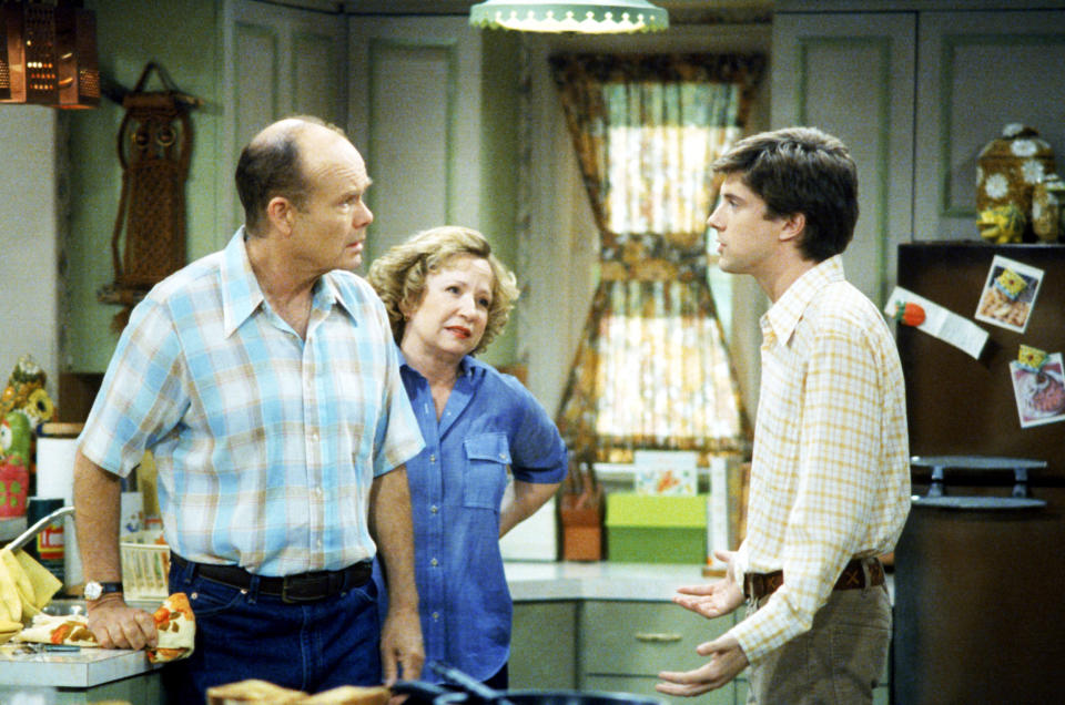 Red, Kitty, and Eric talking in the kitchen