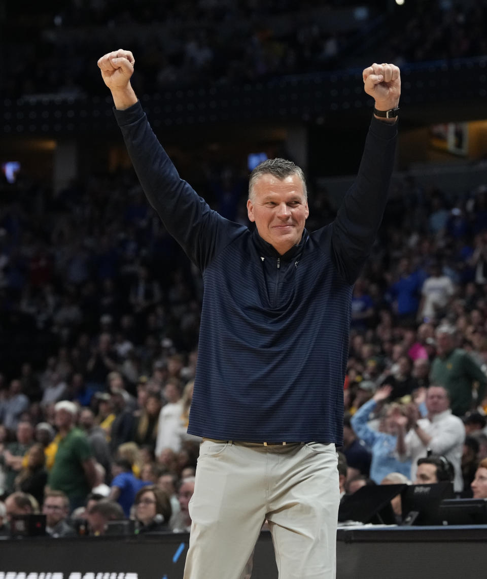 Creighton coach Greg McDermott raises his arms as time runs out in the team's second-round college basketball game against Baylor in the men's NCAA Tournament on Sunday, March 19, 2023, in Denver. (AP Photo/David Zalubowski)