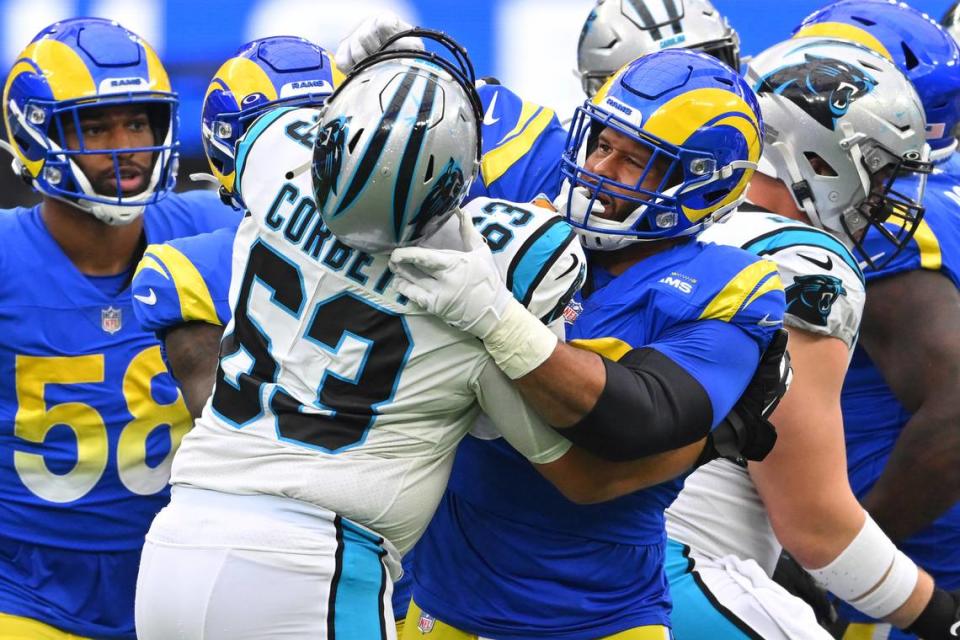 Los Angeles Rams defensive tackle Aaron Donald, right, gets into a shoving match with Carolina Panthers guard Austin Corbett (63) during the second half of an NFL football game Sunday, Oct. 16, 2022, in Inglewood, Calif. (AP Photo/Jayne Kamin-Oncea)