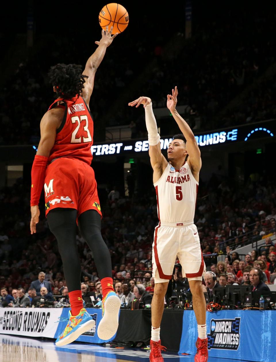 Mar 18, 2023; Birmingham, AL, USA; Alabama guard Jahvon Quinerly (5) shoots a three over Maryland guard Ian Martinez (23) at Legacy Arena during the second round of the NCAA Tournament. Alabama advanced to the Sweet Sixteen with a 73-51 win over Maryland. Mandatory Credit: Gary Cosby Jr.-Tuscaloosa News