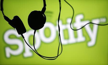 Headsets hang in front of a screen displaying a Spotify logo on it, in Zenica February 20, 2014. REUTERS/Dado Ruvic
