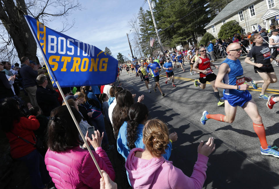 Race fans cheer runners as they start the 118th Boston Marathon Monday, April 21, 2014. in Hopkinton, Mass. (AP Photo/Michael Dwyer)