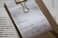 In this Feb. 11, 2020, photo, a line item shows an example of how the charge that Brent Frederick, founder of Jester Concepts, a restaurant group in Minneapolis uses as a 3% voluntary surcharge on guest checks to help pay for health insurance and mental health services and says almost all guests agree to pay it. (AP Photo/Andy Clayton-King)