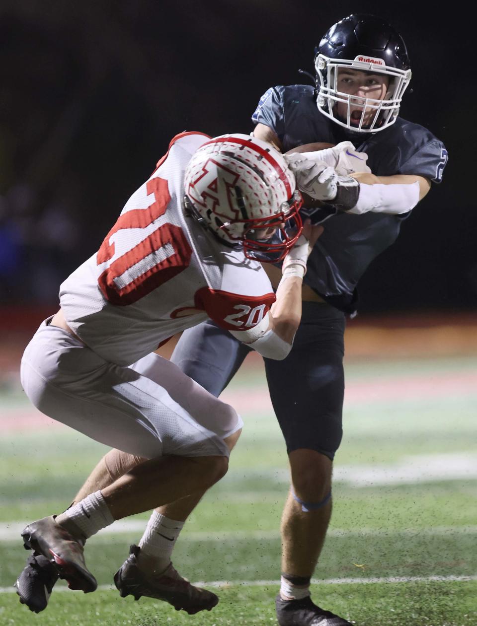 Cohasset running back Liam Appleton runs over Amesbury defender Michael Sanchez for a touchdown during a game on Friday, Nov. 17, 2023.