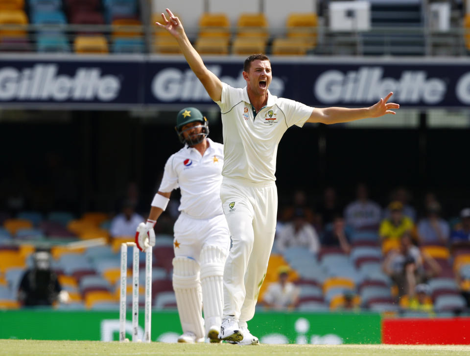 Australia's Josh Hazlewood, right, appeals for the wicket of Pakistan's Yasir Shah, left, during their cricket test match in Brisbane, Australia, Sunday, Nov. 24, 2019. (AP Photo/Tertius Pickard)