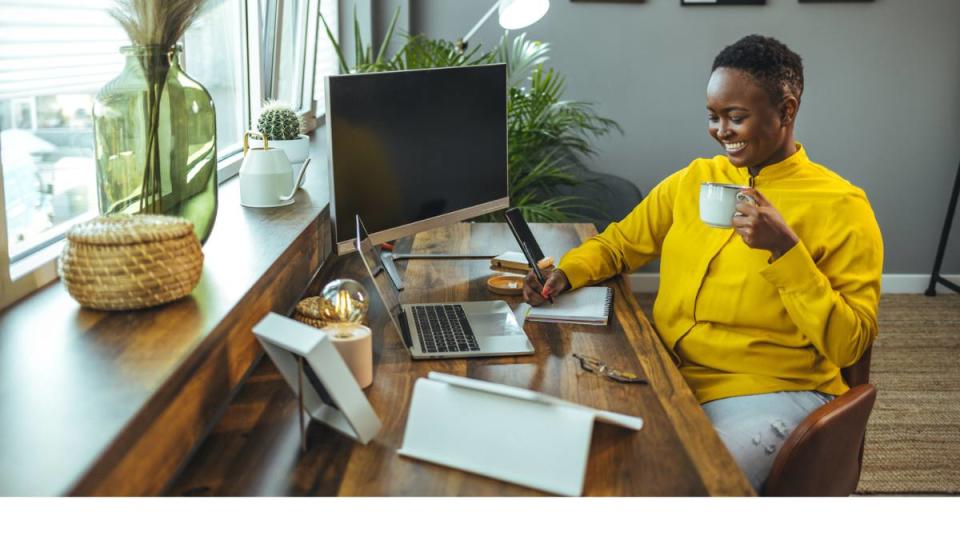 Work from home typing jobs: Cropped shot of a beautiful young woman writing in her notebook while sitting at home