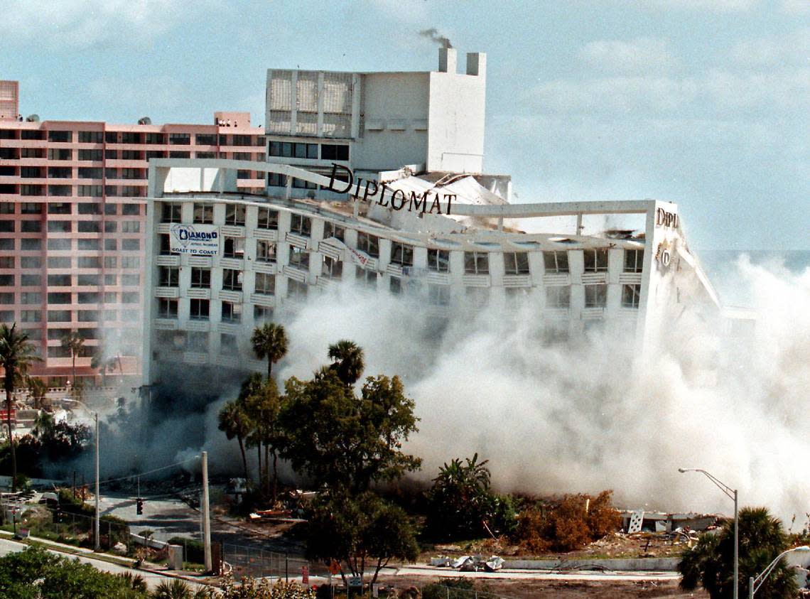 Seconds after its implosion begins, the Diplomat Hotel and one of its signature signs sways toward the ground in Hollywood.