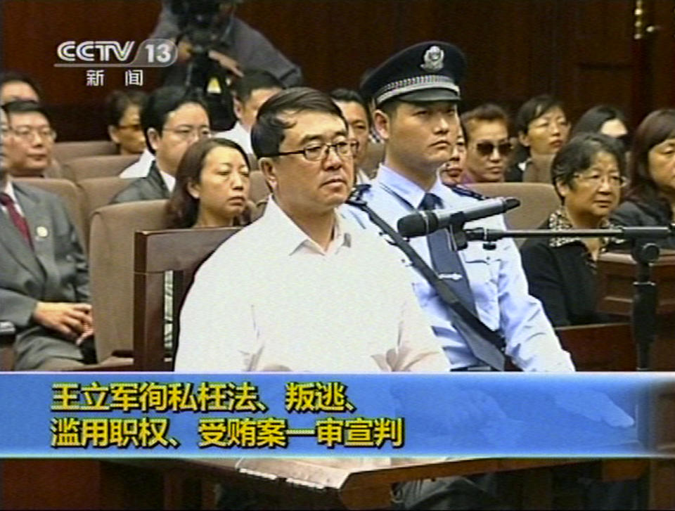 In this Sept. 24, 2012 video image taken from CCTV, Wang Lijun sits in the Intermediate People's Court during his trial in Chengdu, in southwestern China's Sichuan province. The Chinese police chief whose thwarted defection exposed murder and infighting in high places was sentenced to 15 years in prison Monday, setting the stage for China's leadership to close out the divisive scandal and move ahead with a generational handover of power. (AP Photo/CCTV via AP video) CHINA OUT, TV OUT