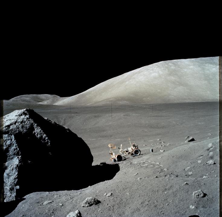 (13 Dec. 1972) — The Apollo 17 Lunar Roving Vehicle (LRV) is photographed near a large lunar boulder during the third Apollo 17 extravehicular activity (EVA) at the Taurus-Littrow landing site. About half of the boulder is captured in this scene, photographed by astronaut Eugene A. Cernan, mission commander. (NASA)