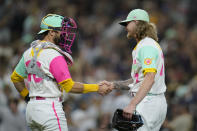 San Diego Padres catcher Austin Nola, left, celebrates with relief pitcher Josh Hader after the Padres defeated the Chicago White Sox 5-2 in a baseball game Saturday, Oct. 1, 2022, in San Diego. (AP Photo/Gregory Bull)