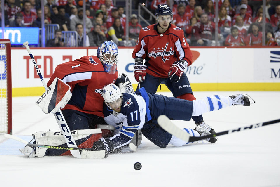 Winnipeg Jets center Adam Lowry (17) collides into Washington Capitals goaltender Pheonix Copley (1) during the second period of an NHL hockey game, Sunday, March 10, 2019, in Washington. Also seen is Capitals defenseman Dmitry Orlov (9), of Russia. (AP Photo/Nick Wass)