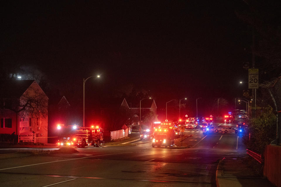 Arlington County Fire Department fire and police vehicles fill the street near the scene of a house explosion on Monday, Dec. 4, 2023, in Arlington, Va. (AP Photo/Kevin Wolf)