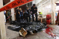 Israeli paramedics work at near a body of a person killed by a gunman in Bnei Brak, Israel, Tuesday, March 29, 2022. The circumstance of the deadly incident in the city east of Tel Aviv were not immediately clear. (AP Photo/Ofer Vaknin) ISRAEL OUT