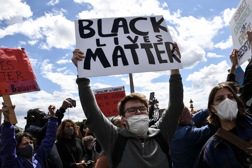 People with placards reading 'Black Lives Matter' gather on the place de la Concorde, near the US embassy compound, in Paris on June 6, 2020, during a rally called as part of a weekend of global rallies worldwide against racism and police brutality in the wake of the death of George Floyd, an unarmed black man killed while apprehended by police in Minneapolis, US. - Police banned the rally as well as a similar second one on the Champs de Mars park facing the Eiffel Tower today, saying the events were organised via social networks without official notice or consultation. But on June 2, another banned rally in Paris drew more than 20000 people in support of the family of Adama Traore, a young black man who died in police custody in 2016. (Photo by Anne-Christine POUJOULAT / AFP) (Photo by ANNE-CHRISTINE POUJOULAT/AFP via Getty Images)