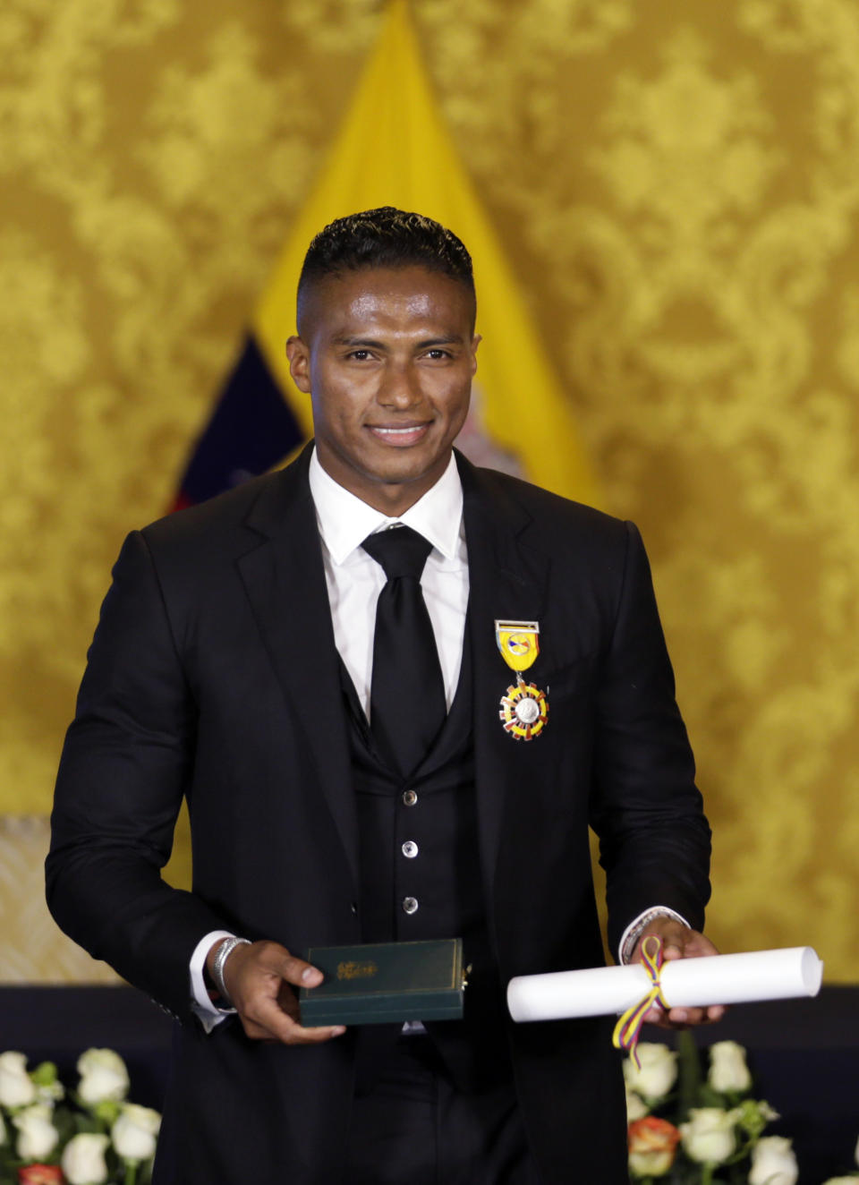 Soccer star Antonio Valencia poses for a photo after a ceremony in which the fullback was decorated with a National Order of Merit, in Quito, Ecuador, Tuesday, May 14, 2019. The Ecuadorian's final game with Manchester United was Sunday, after 10 seasons with the team. (AP Photo/Dolores Ochoa)