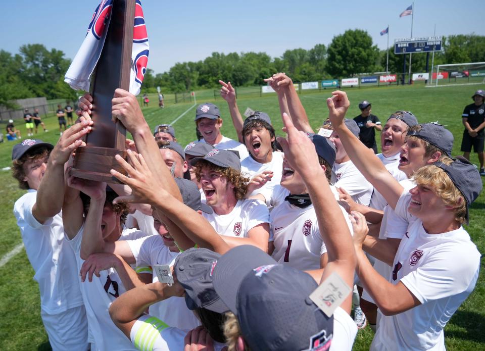 Members of the Western Christian boys soccer team celebrate a Class 1A state soccer championship win over Grundy Center/Gladbrook-Reinbeck on Saturday in Des Moines.