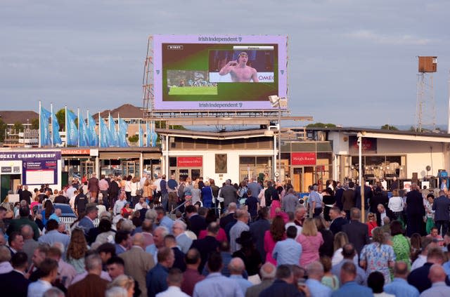 Racegoers at Galway Racecourse celebrate as they watch Ireland’s Daniel Wiffen on the big screen as he wins the men’s 800m freestyle final at the Paris Olympic Games 