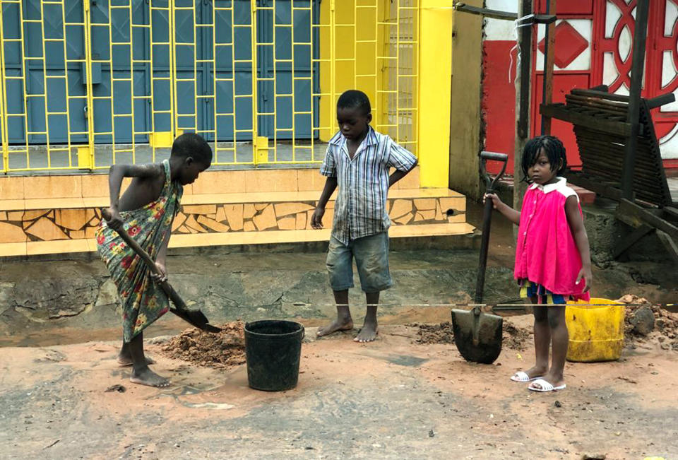 Children clear away mud due to flooding in Pemba, Mozambique, Sunday, April 28, 2019. Serious flooding began on Sunday in parts of northern Mozambique that were hit by Cyclone Kenneth three days ago, with waters waist-high in areas, after the government urged many people to immediately seek higher ground. Hundreds of thousands of people were at risk. (AP Photo/Tsvangirayi Mukwazhi)
