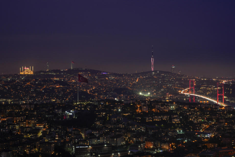 Backdropped by the Camlica mosque, top left, and Camlica tower, cars cross July 15 Martyrs' bridge, right, that connects European and Asian sides of Istanbul, Turkey, Tuesday, March 19, 2024. (AP Photo/Emrah Gurel)