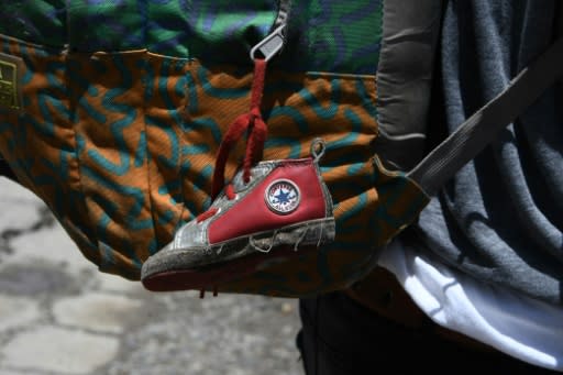 A little shoe that belongs to his baby girl hangs from the backpack of Honduran immigrant Ever Sierra, 28, who was deported from the US and arrived in San Pedro Sula, 200 kilometres north of Tegucigalpa on June 22, 2018