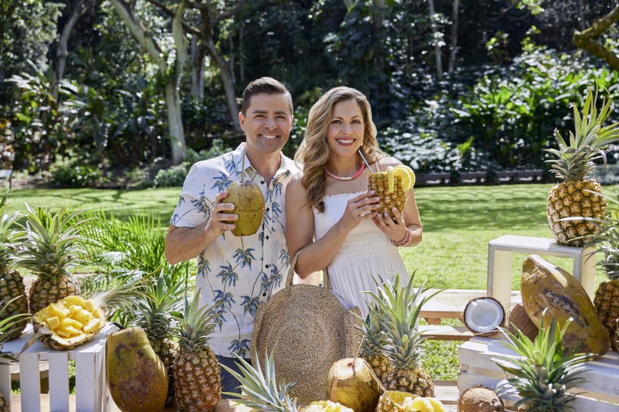 Kavan Smith and Pascale Hutton Holding Pineapple drinks