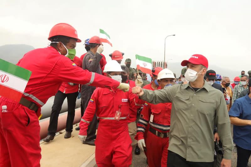 A worker of the state-oil company Pdvsa greets Venezuela's Oil Minister Tarek El Aissami during the arrival of the Iranian tanker ship "Fortune" at El Palito refinery in Puerto Cabello