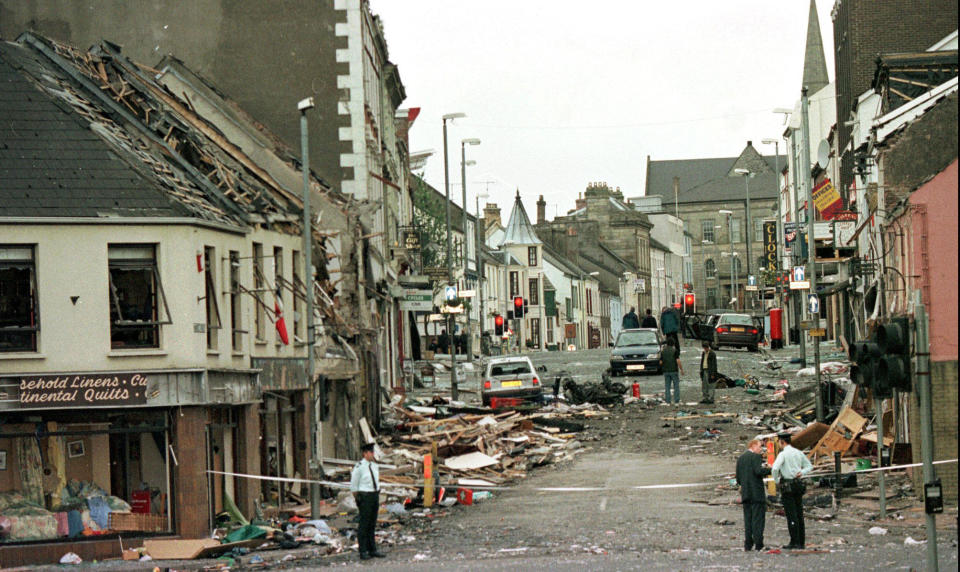 An Aug. 15, 1998 file photo shows Royal Ulster Constabulary Police officers standing on Market Street, the scene of a car bombing in the center of Omagh, Co Tyrone, 72 miles west of Belfast, Northern Ireland. / Credit: Paul McErlane/AP