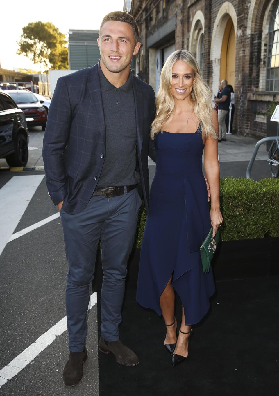 <p>Phoebe looked gorgeous in a three-quarter length navy dress paired with a green oversize clutch.</p>