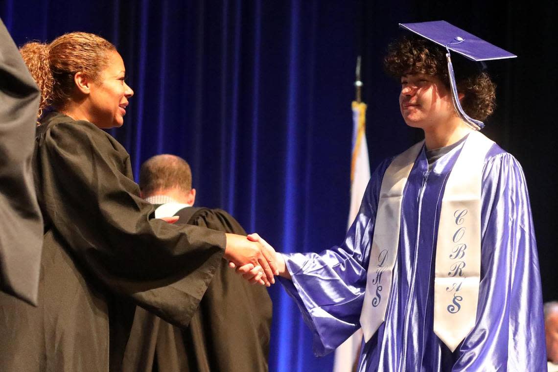 Fresno Unified School District Trustee Keshia Thomas with one of the DeWolf High School seniors during the summer commencement at Roosevelt High School’s Audra McDonald Theater Friday morning. María G. Ortiz-Briones/mortizbriones@vidaenelvalle.com
