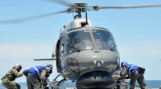 In this photo released by The Royal Malaysian Navy, a Royal Malaysian Navy Fennec helicopter prepares to depart to aid in the search and rescue efforts for the missing Malaysia Airlines plane over the Straits of Malacca. Photo: AP.