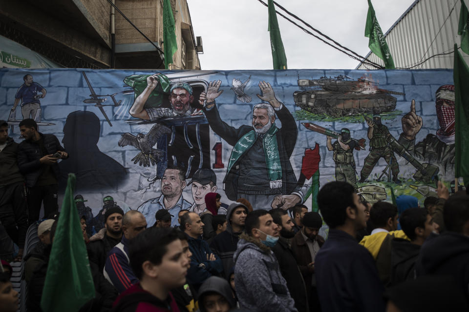 Palestinians attend a rally marking the 34th anniversary of Hamas movement's founding, in Gaza City, Friday, Dec. 17, 2021. Gaza’s Hamas rulers collect millions of dollars a month in taxes and customs at a crossing on the Egyptian border – providing a valuable source of income that helps it sustain a government and powerful armed wing. After surviving four wars and a nearly 15-year blockade, Hamas has become more resilient and Israel has been forced to accept that its sworn enemy is here to stay. (AP Photo/ Khalil Hamra)