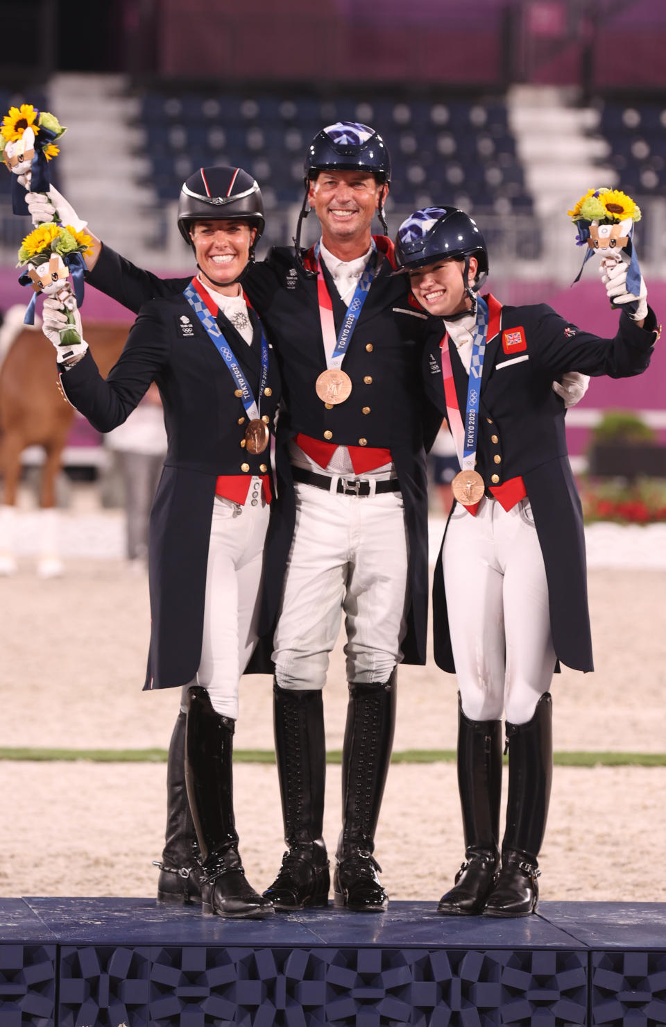 <p>TOKYO, JAPAN - JULY 27: Bronze medalist Charlotte Dujardin, Carl Hester and Charlotte Fry of Team Great Britain pose on the podium during the medal ceremony for the Dressage Team Grand Prix Special Team Final on day four of the Tokyo 2020 Olympic Games at Equestrian Park on July 27, 2021 in Tokyo, Japan. (Photo by Julian Finney/Getty Images)</p> 