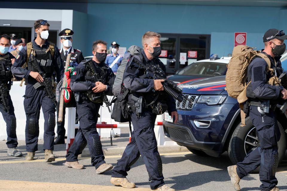 Italian Carabinieri leave the airport after disembarking from Italy's final evacuation flight of refugees from Afghanistan, (AP)