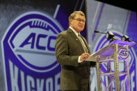 FILE - In this July 18, 2018, file photo, Atlantic Coast Conference commissioner John Swofford speaks during a news conference at the ACC NCAA college football media day in Charlotte, N.C. Atlantic Coast Conference Commissioner John Swofford is retiring after the 2020-21 academic year, ending his tenure after 24 years. Swofford, 71, has been commissioner of the ACC since 1997, the longest run in that position in the history of the 67-year-old conference. (AP Photo/Chuck Burton, File)