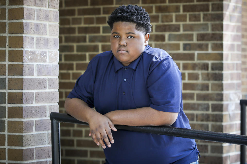 In this Sept. 26, 2021, photo Royal Smart poses for a portrait in a Chicago park. Smart still has nightmares about being handcuffed for nearly 30 minutes when he was 8-years-old, alongside his mother and other adults. Neither he nor anyone else was arrested at his family's home on Chicago's South Side when police wielding a warrant came looking for illegal weapons and found none. (AP Photo/Teresa Crawford)