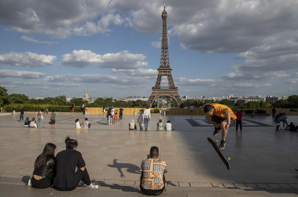 People stroll at Trocadero square near the Eiffel Tower in Paris. 