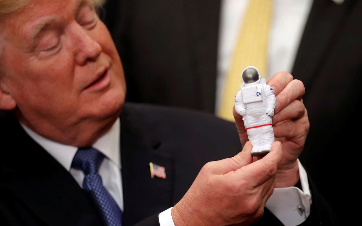 Donald Trump with an astronaut toy at the White House - REUTERS