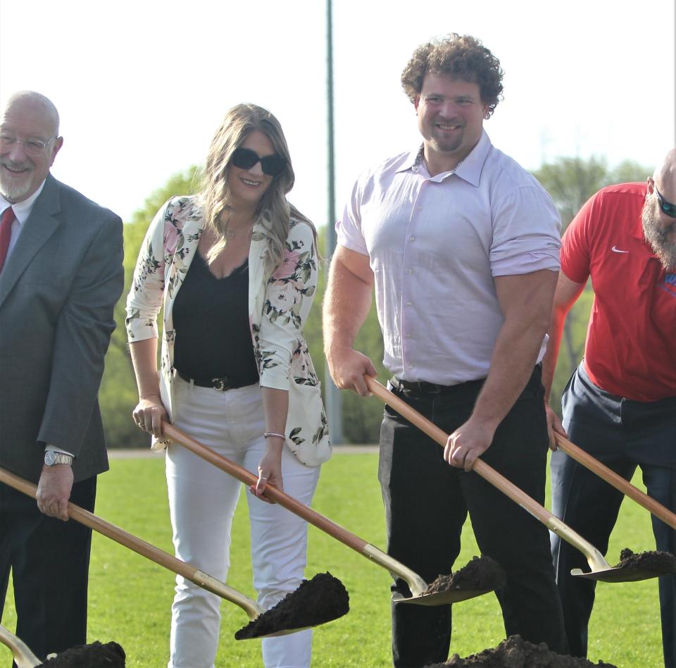 Former Wisconsin Lutheran football standout Kevin Zeitler and his wife, Sara, participate in the ground-breaking ceremony for the school new athletic complex. The Zeitlers, both graduates of the school, were major contributors to the project.