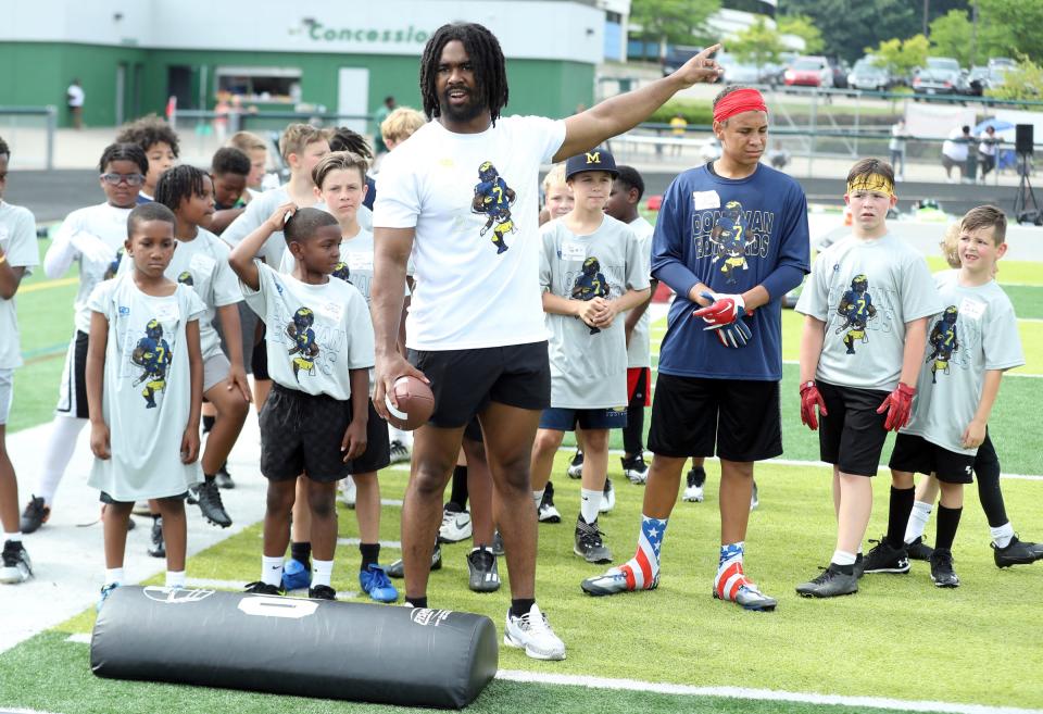Michigan running back Donovan Edwards demonstrates a drill during his football camp Saturday, July 1, 2023, at West Bloomfield High School.