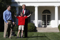 <p>Frank Giaccio, 11, of Falls Church, Va., holds his arms up in the air after being surprised by President Donald Trump, Friday, Sept. 15, 2017, while mowing the lawn of the Rose Garden at the White House in Washington. The 11-year-old, who wrote the president requesting to mow the lawn at the White House, was so focused on the job at hand the he didn’t notice the president until he was right next to him. At left is Frank’s father, Greg Giaccio. (Photo: Jacquelyn Martin/AP) </p>