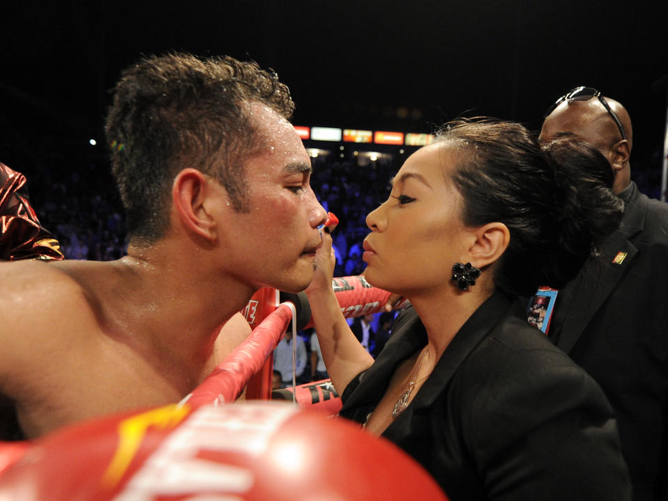 CARSON, CA - OCTOBER 13: Nonito Donaire of The Phillipines gets a kiss from wife Rachel Marcial after his ninth round TKO of Toshioka Nishioka of Japan during the WBO Super Bantamweight Title fight at The Home Depot Center on October 13, 2012 in Carson, California. (Photo by Harry How/Getty Images)