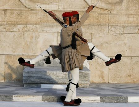 Greek presidential guards perform a ceremonial march at the Tomb of the Unknown Soldier in front of the parliament building in Athens, Greece, September 12, 2015. REUTERS/Paul Hanna