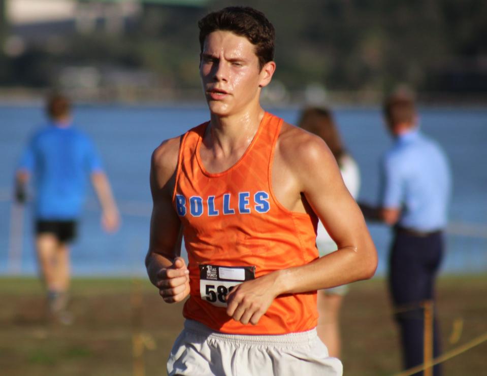 Chris Joost (5825) of Bolles leads the pack during the FHSAA District 2-2A high school boys cross country meet.