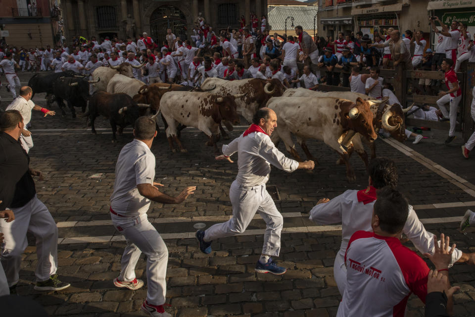 Revellers run with Cebada Gagos's fighting bulls before at Plaza Consistorial during the third day of the San Fermin Running of the Bulls festival on July 8, 2019 in Pamplona, Spain. (Photo: Pablo Blazquez Dominguez/Getty Images)