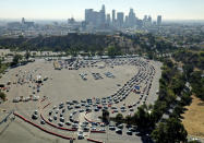 Drivers are in long lines at a COVID-19 testing site in a parking lot at Dodger Stadium on Tuesday, Nov. 17, 2020, in Los Angeles. (Dean Musgrove/The Orange County Register via AP)