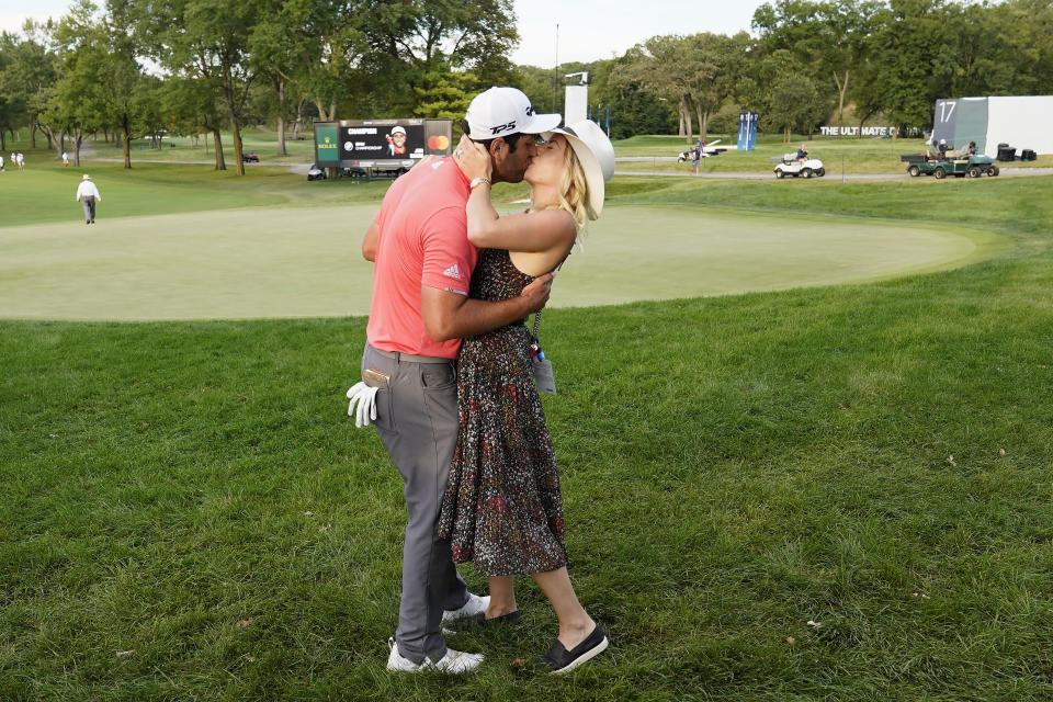 Jon Rahm, left, celebrates with his wife, Kelley Cahill, after winning the BMW Championship golf tournament at the Olympia Fields Country Club in Olympia Fields, Ill., Sunday, Aug. 30, 2020. (AP Photo/Charles Rex Arbogast)